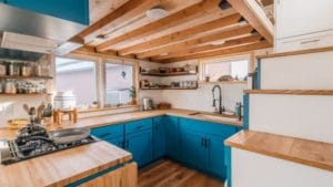 Tiny home kitchen with bright cabinet colors.