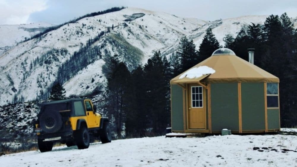 A yurt tiny home in snowy mountains.