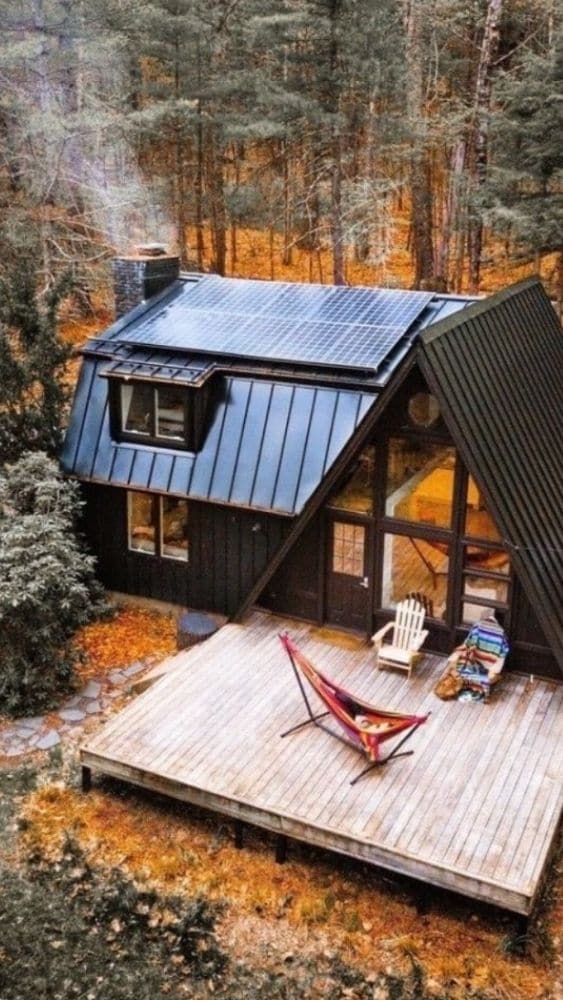 A-frame tiny house with an extension on one side.
