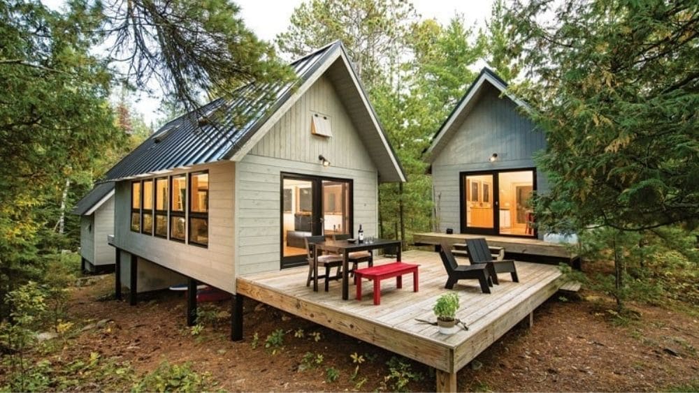 Two A-frame tiny homes with a shared deck.