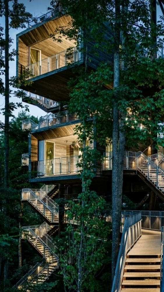 Two-level tiny home with exterior stairs and a lower deck.