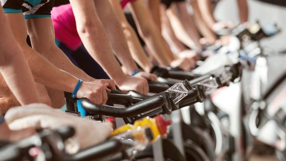 row of people on bikes in a spin class
