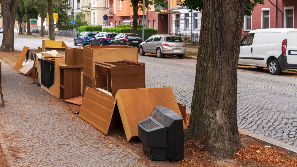 Furniture on the curb of a street.