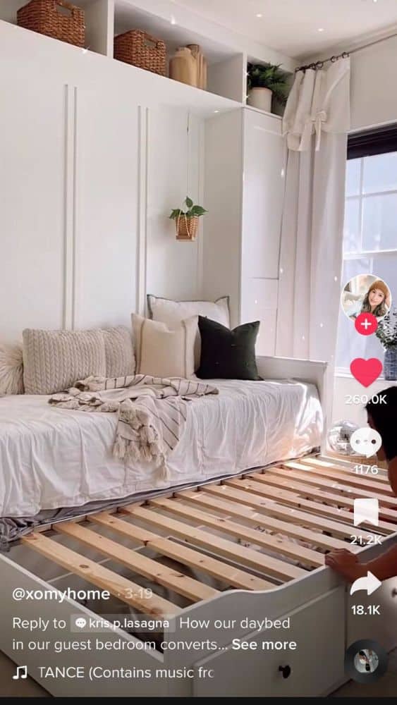 Screenshot from @xomyhome's TikTok video showing a daybed with a trundle beneath that converts the bed into a king-size.